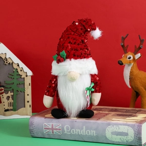 Christmas gnome doll with red sequin hat and white beard on a festive holiday background