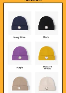 Multiple colors of ribbed knit beanies with embroidered smiley face patch on display