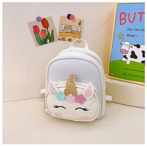 Detail of cute white unicorn backpack with gold horn and colorful sequin stars for girls