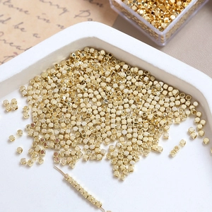Macro shot of 14k gold plated faceted cube beads for DIY handmade jewelry crafting