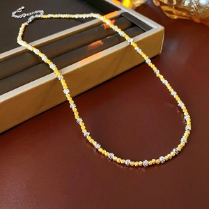 Detailed close-up of 18k gold and silver plated twist chain necklace with lobster clasp