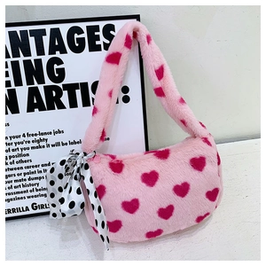 Detail of pink plush heart tote bag with soft texture and stylish polka dot scarf