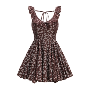 Detail of vintage brown daisy polka dot dress showing ruffle straps and tie-back design