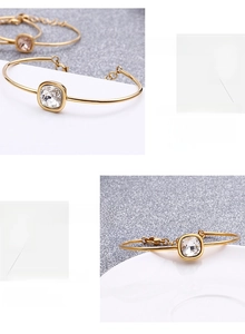 Macro view of 18k gold plated stainless steel bracelet with square zircon and lobster clasp