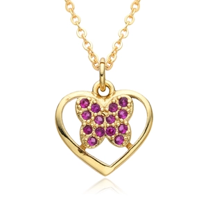 Macro detail of golden hollow heart pendant featuring a purple gemstone butterfly design