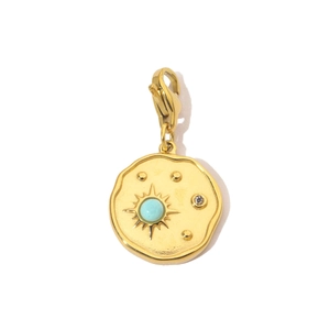Close-up of a gold-plated pendant with light blue stone and lobster clasp detail