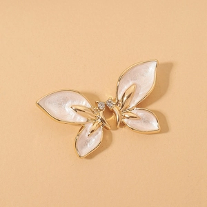 Elegant butterfly stud earrings in gold and pearl white enamel with sparkling crystals