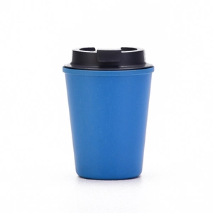 Close-up of blue wheat straw coffee cup with black lid and matte textured surface