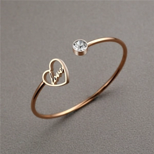 Rose gold stainless steel heart bracelet with love engraving and a sparkling crystal