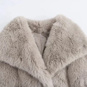 Close-up of the plush texture and large lapel of this grey faux fur coat for women
