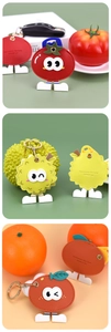 Detail view of cartoon fruit leather keychains with tomato and durian designs