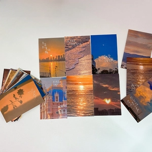 Detail of aesthetic sunset postcards featuring warm quotes and scenic wall decor