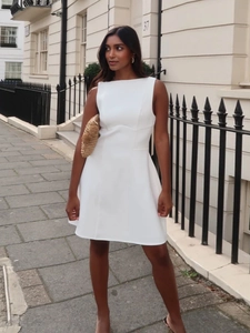 Elegant white sleeveless boat neck A-line dress with a cinched waist and structured fabric