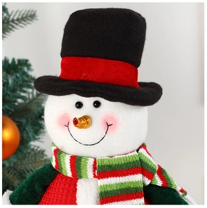 Close-up of a plush Christmas snowman doll with a knit scarf and top hat decoration
