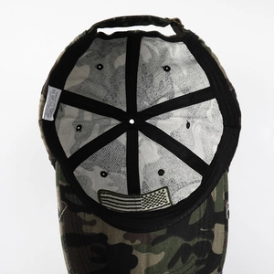 Detailed interior view of the camouflage cotton baseball cap showing seams and care label