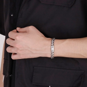 Polished silver stainless steel 9mm curb chain bracelet for men worn on black sleeve