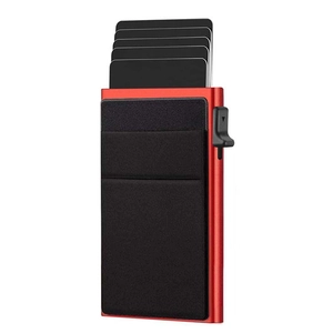 Detail of red RFID aluminum card holder showing pop-up mechanism and black fabric pocket