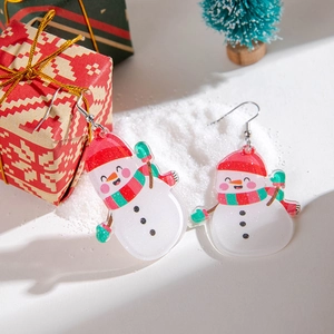 Detail shot of acrylic Christmas snowman earrings with festive holiday gift background