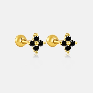 Detailed view of gold clover earrings with black gems and secure screw-back closures