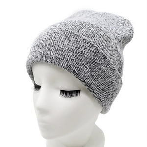 Detail shot of the grey knit beanie featuring a vertical ribbed pattern and cuffed design