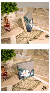 Detail of square gray paper jewelry gift box featuring elegant Chinese lotus illustration