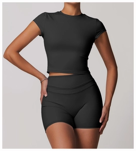 Close-up of matte black cropped gym top and high-waisted shorts showing seamless hem