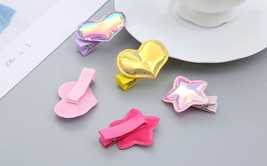 Close-up of holographic heart and star hair clips with ribbon-wrapped metal bases