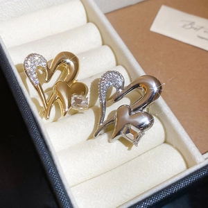 Detailed macro view of interlocking double heart brooches with pave crystals and rectangle stones