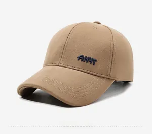 Detail view of khaki baseball cap featuring navy AHYT embroidery and twill texture