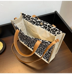 Interior detail of leopard print tote bag showing magnetic closure and inner pockets