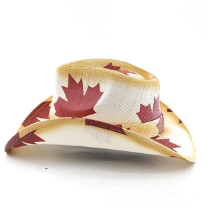 Detail of hand-woven western cowboy hat featuring red maple leaf patterns and curved brim