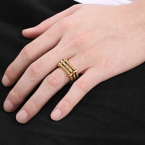 Detailed view of a gold punk gear ring featuring three sparkling square zircons on the band