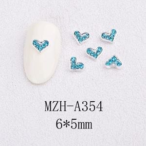 Macro detail of 6x5mm lake blue heart rhinestones for nail art with alloy base