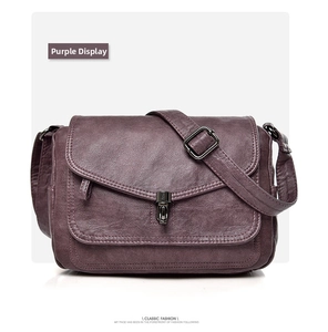 Detailed view of purple retro faux leather shoulder bag with metallic buckle and strap