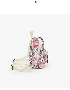 Side view of mini floral canvas backpack featuring pink rose print and black zippers