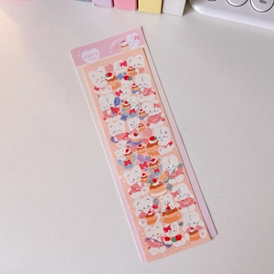 Close-up of cute pudding-themed stickers with white rabbit characters on a pink card