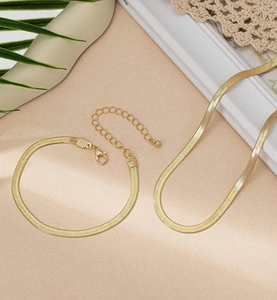 Polished gold flat snake chain necklace and bracelet set with lobster claw clasp and extender