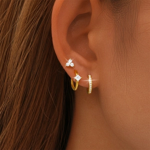 Detailed view of three-piece gold S925 silver earring set with zircon on model ear