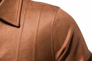 Macro shot of brown suede jacket collar showing exquisite stitching and fine fabric texture