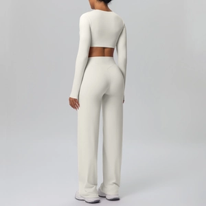 Detail view of cream long sleeve crop top and high-waist wide leg yoga pants from behind