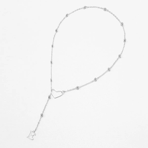 Detail of silver beaded chain necklace featuring hollow heart and letter E pendant