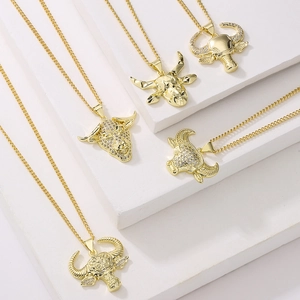 Five 18K gold plated bull head necklaces with zircon crystals on white stands