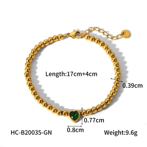 Detail of 18K gold stainless steel beaded bracelet with green heart stone and lobster clasp