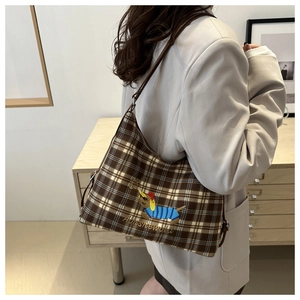 Detail of brown plaid tote bag featuring exquisite dachshund embroidery and texture
