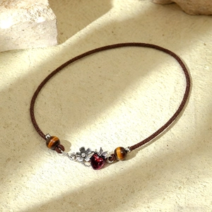 Vintage necklace with tiger eye beads and red strawberry flower pendant on a rope chain