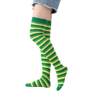 Close-up of St. Patrick's Day over-knee socks featuring green and yellow horizontal stripes