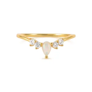 Macro shot of V-shaped gold ring with pear-cut opal and S925 hallmark engraving