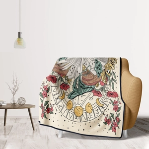Detail of soft flannel throw blanket featuring mystical moth and moon phase patterns