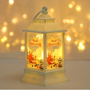 Close-up of white Christmas LED lantern with Merry Christmas print and warm bokeh lighting
