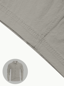 Macro detail of high-quality linen blend fabric texture and stitching on men's casual shirt